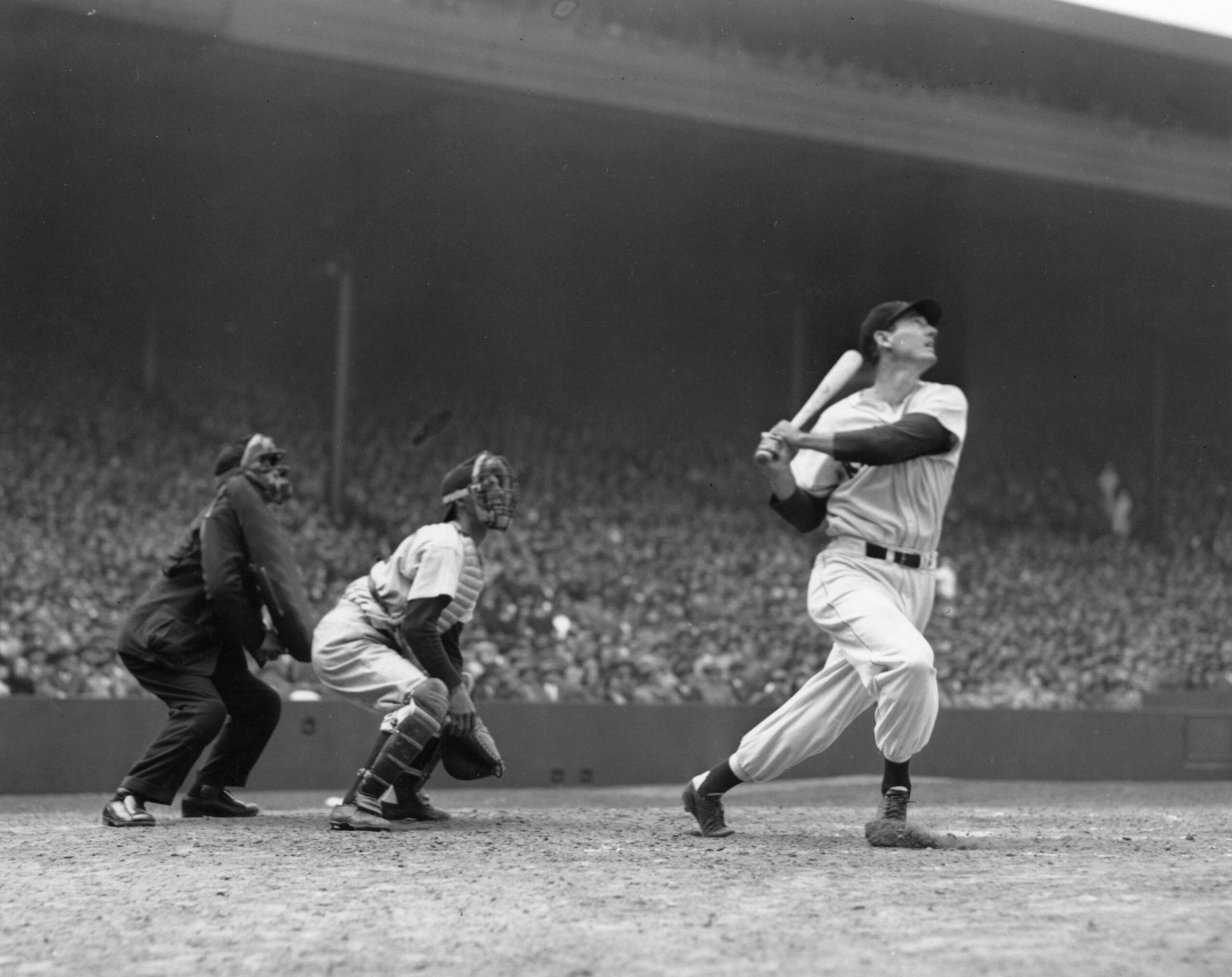 Red Sox leftfielder Ted Williams hits a home run at Fenway Park in 1948.