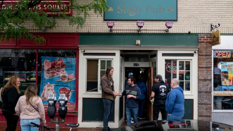 Patrons conversed outside of Sligo Pub, a dive bar in Davis Square, which closed after 75 years.