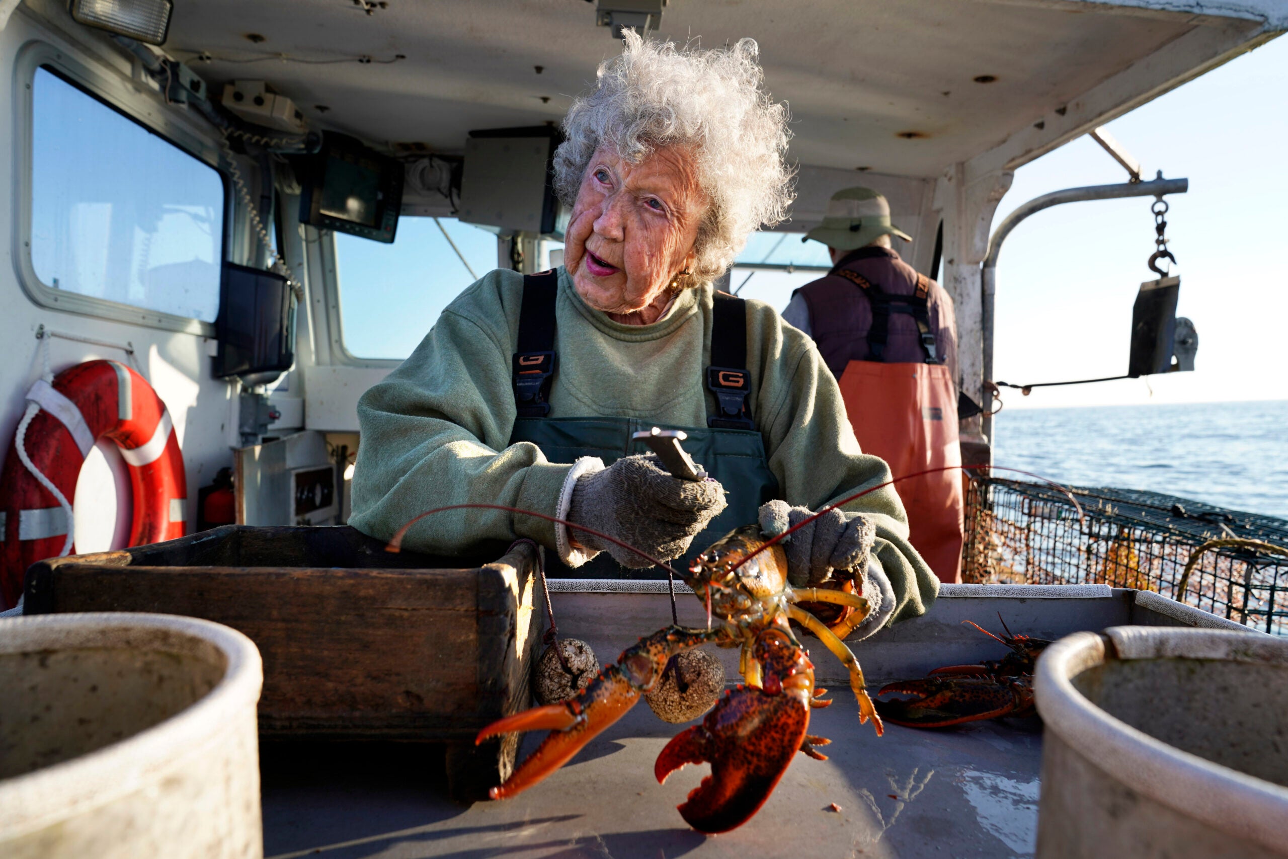 Virginia Oliver, 103, works as a sternman, measuring and banding lobsters off Rockland, Maine.