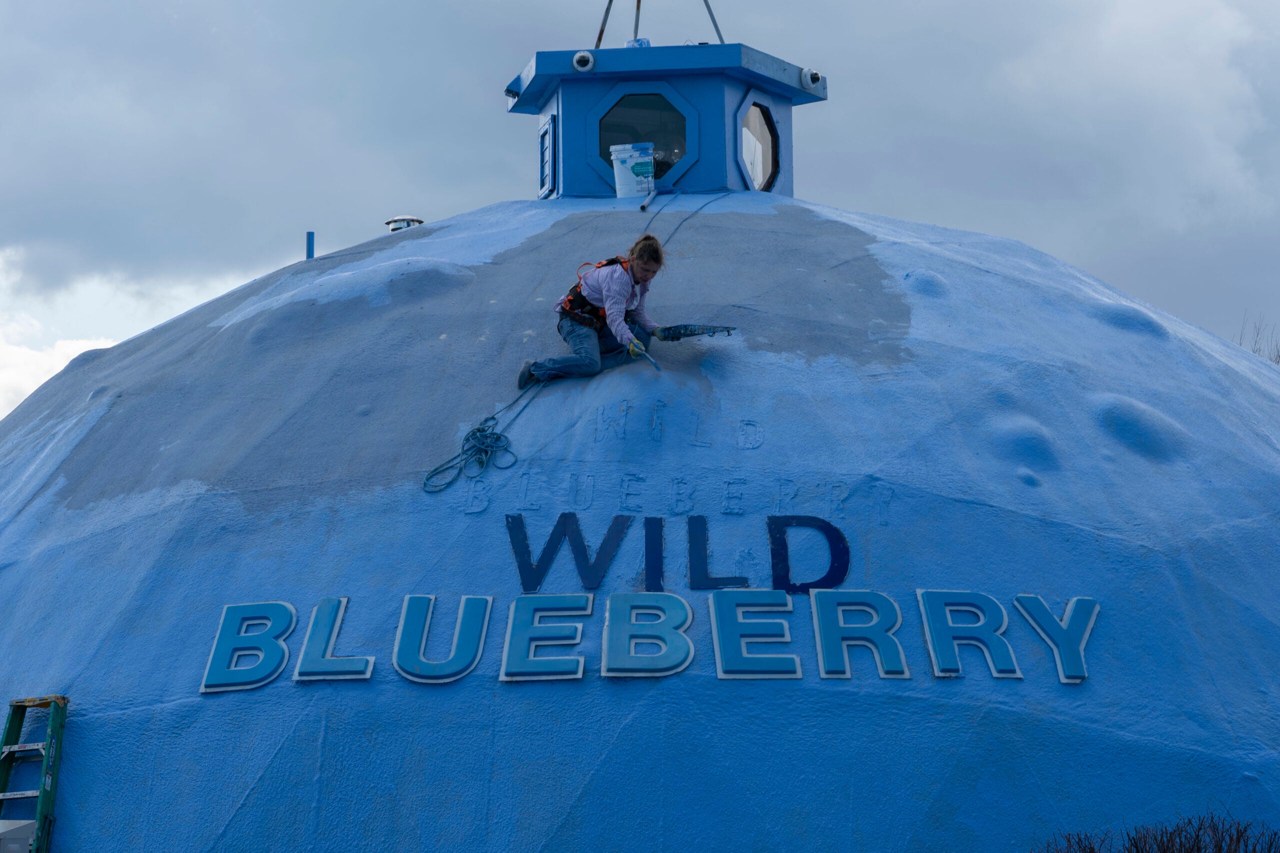 A fresh coat of paint is applied to a dome building at the Wild Blueberry Heritage Center in Columbia Falls, Maine.