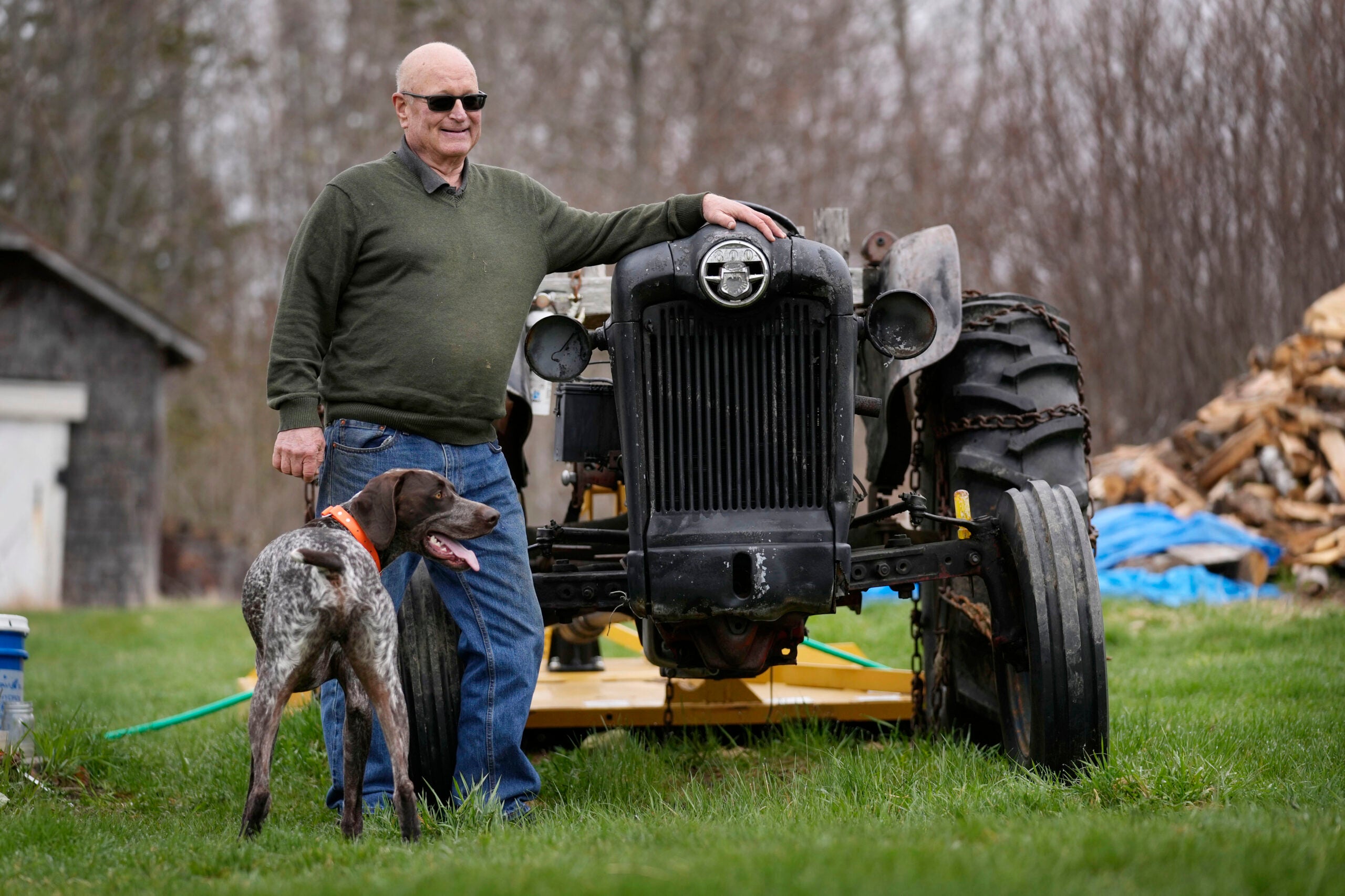 Charlie Robbins stands next to his tractor.