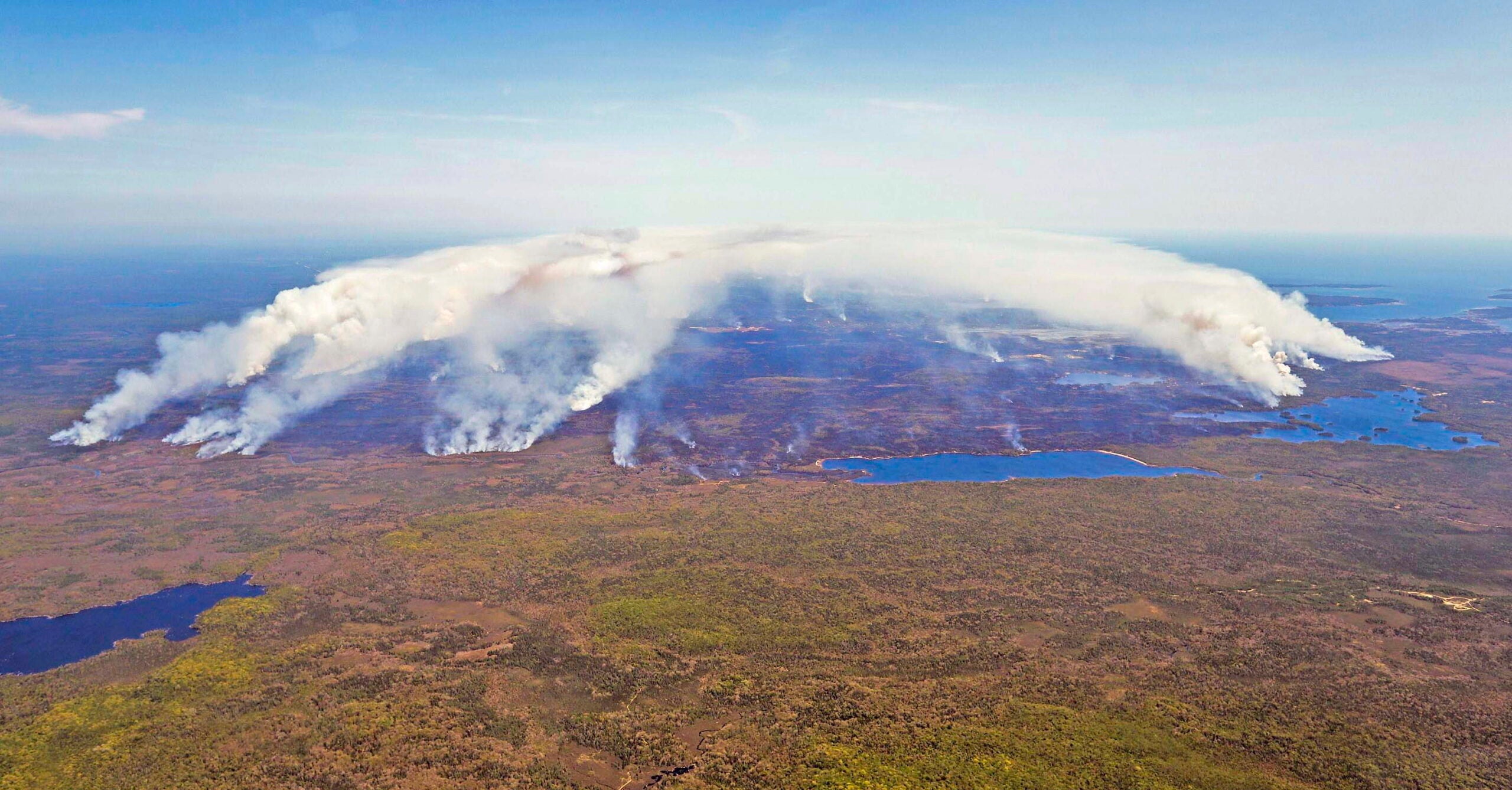 Smoke billows over a forest from wildfires in Nova Scotia