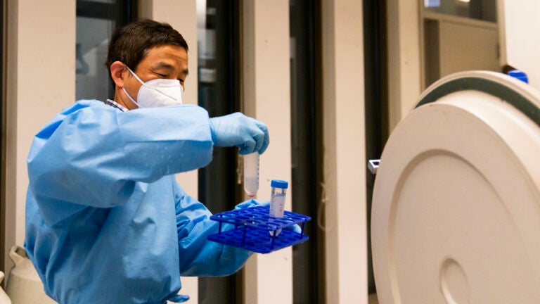 Research scientist Yi Yang retrieves samples at UW Medicine's Cancer Vaccine Institute in Seattle.