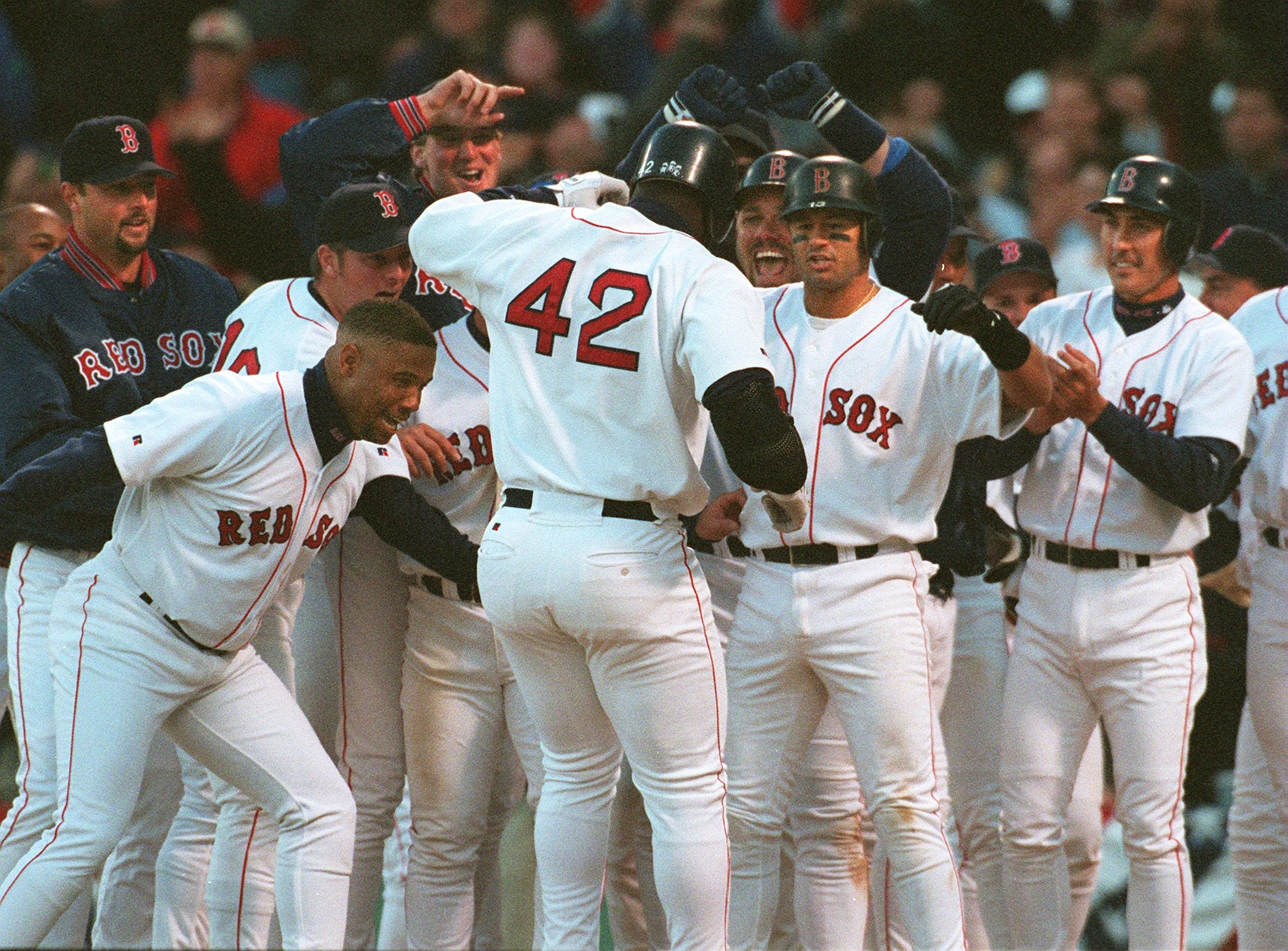 The Red Sox swarmed Mo Vaughn following his walk-off grand slam against the Mariners in 1998. 