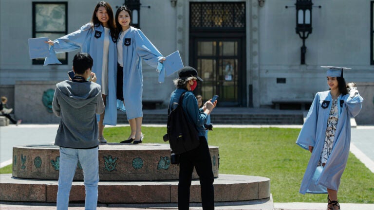 Columbia University class of 2020 graduates pose for photographs on Commencement Day.