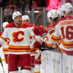 Calgary Flames left wing Milan Lucic celebrates with teammates after scoring a goal against the Arizona Coyotes in the first period during an NHL hockey game, Wednesday, Feb. 22, 2023, in Tempe, Ariz.