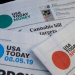Sections of a USA Today newspaper are displayed