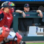 Cleveland Guardians manager Terry Francona, right, watches a baseball game against the Minnesota Twins.