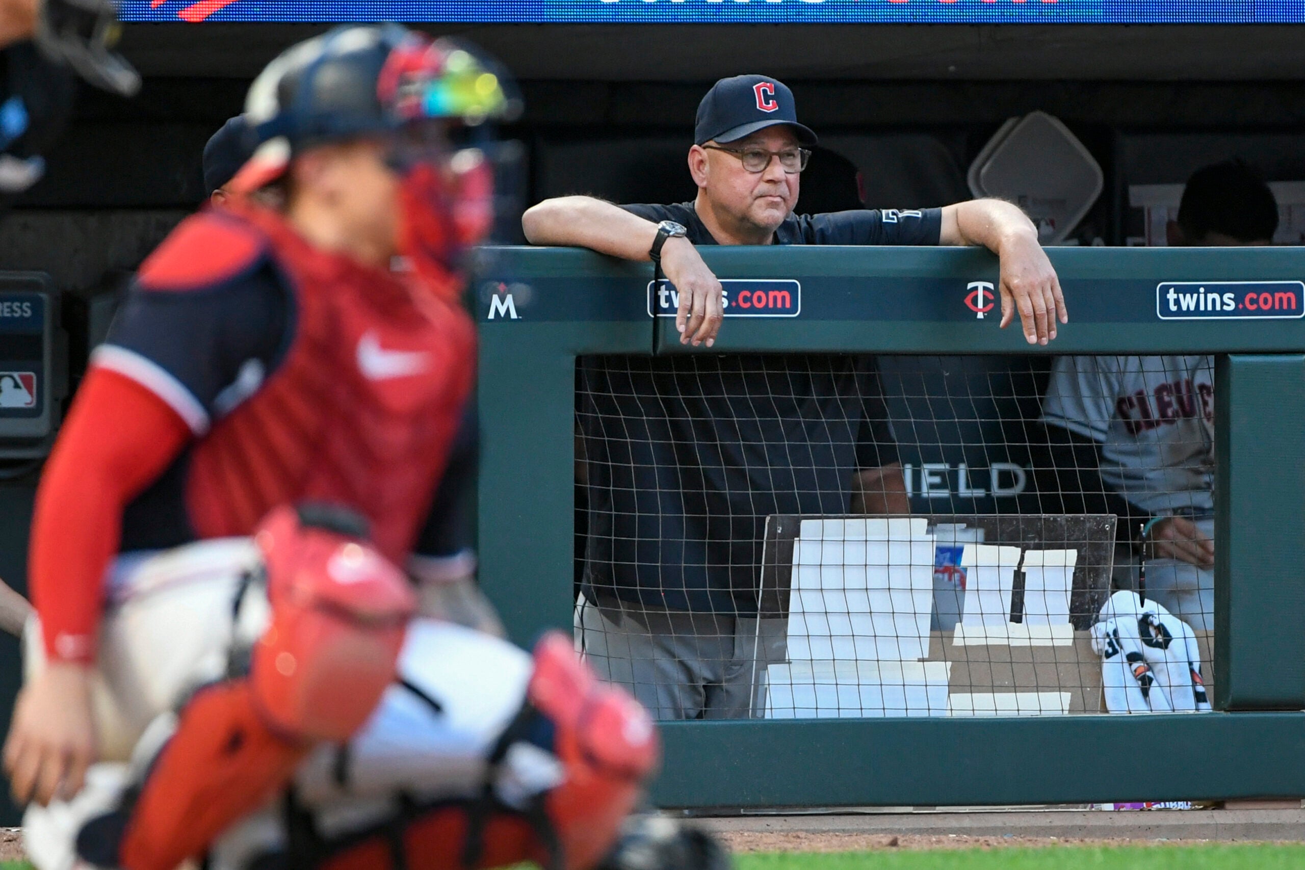 Cleveland Guardians manager Terry Francona, right, watches a baseball game against the Minnesota Twins.