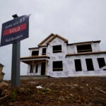 a home under construction without siding is used to illustrate the weekly mortgage rate.