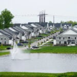 A housing development with a fountain in the foreground is used to illustrate a story on mortgage rate.