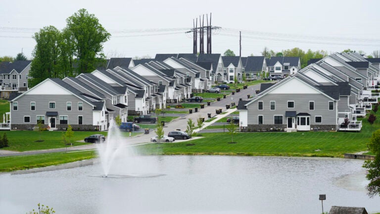 A housing development with a fountain in the foreground is used to illustrate a story on mortgage rate.