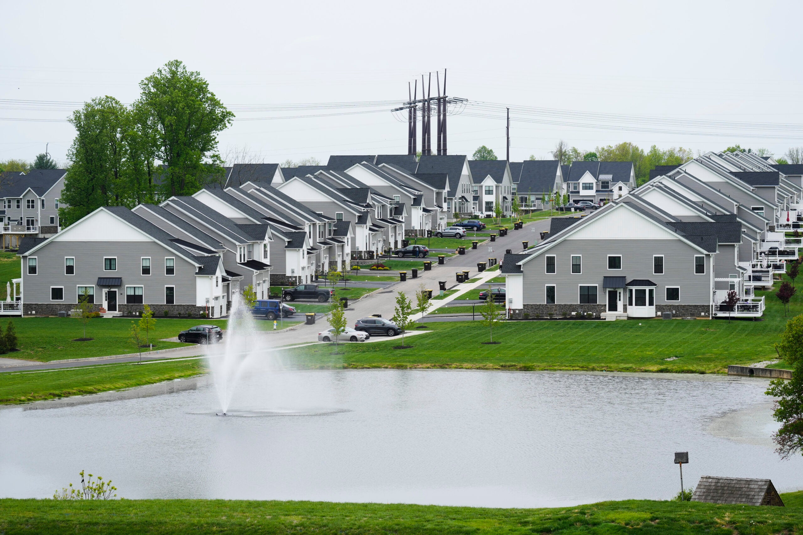 A housing development with a fountain in the foreground is used to illustrate a story on mortgage rate.