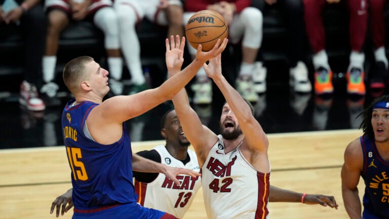 Denver Nuggets center Nikola Jokic (15) drives to the basket over Miami Heat forward Kevin Love (42) during the second half of Game 3 of the NBA Finals.