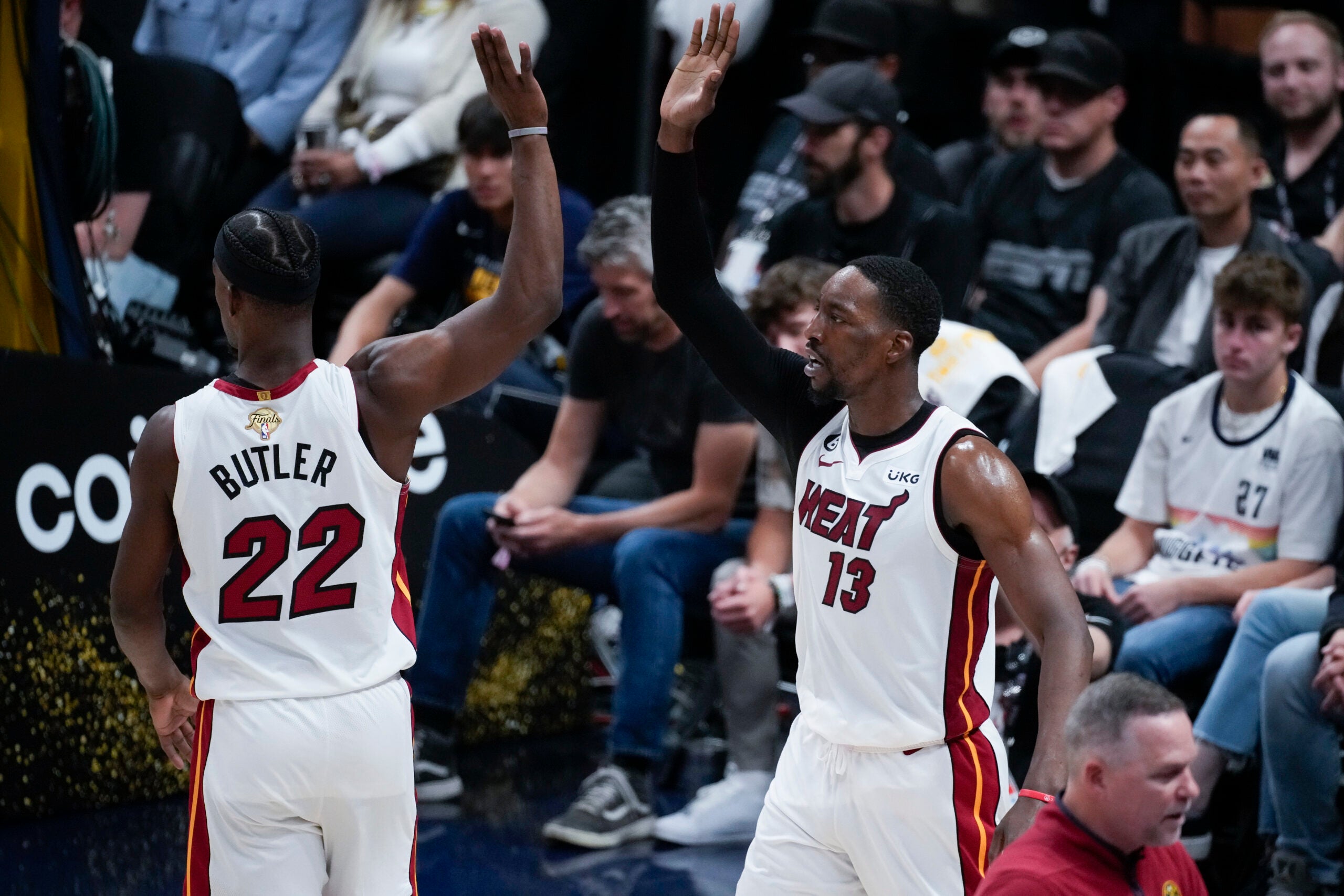 Miami Heat center Bam Adebayo, right, celebrates with forward Jimmy Butler after scoring against the Denver Nuggets during the second half of Game 2 of basketball's NBA Finals.