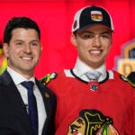 Chicago Blackhawks general manager Kyle Davidson (left) poses with first round draft pick Connor Bedard during the first round of the NHL hockey draft, Wednesday, June 28, 2023, in Nashville, Tenn.
