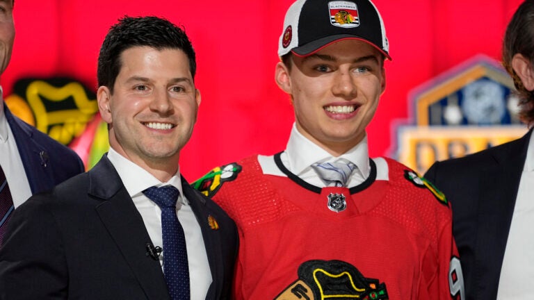 Chicago Blackhawks general manager Kyle Davidson (left) poses with first round draft pick Connor Bedard during the first round of the NHL hockey draft, Wednesday, June 28, 2023, in Nashville, Tenn.