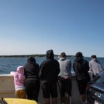 Migrants on a ferry in Vineyard Haven, Mass.