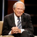 Rev. Pat Robertson poses a question to a Republican presidential candidate during a forum at Regent University in Virginia Beach, Va.