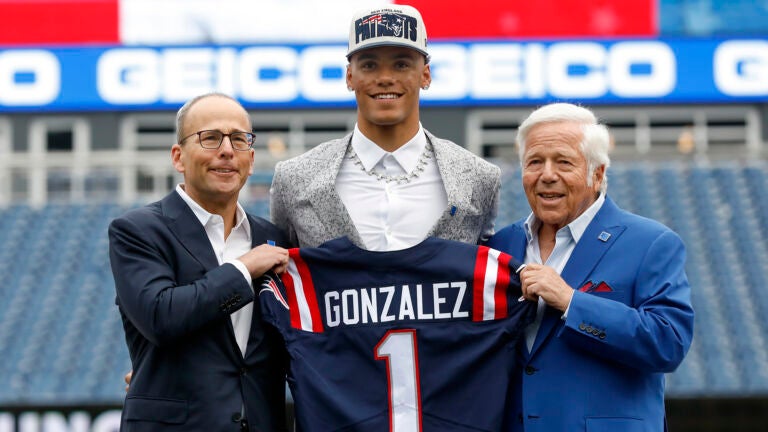 New England Patriots team president Jonathan Kraft, left, first-round pick, cornerback Christian Gonzalez, center, and team owner Robert Kraft, right, hold a team jersey as Gonzalez is introduced to the media at Gillette Stadium, Friday April 28, 2021, in Foxboro, Mass.
