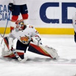 Florida Panthers goaltender Sergei Bobrovsky (72) and defenseman Radko Gudas (7) warm up while wearing a Pride Night hockey jersey.