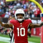 DeAndre Hopkins #10 of the Arizona Cardinals celebrates after scoring a touchdown in the first quarter of a game against the Los Angeles Chargers at State Farm Stadium on November 27, 2022 in Glendale, Arizona.