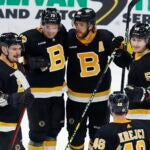 Boston Bruins' David Pastrnak (88) celebrates his goal with Dmitry Orlov (81), Charlie McAvoy (73), Tyler Bertuzzi (59) and David Krejci (46) during the third period of an NHL hockey game against the New York Rangers, Saturday, March 4, 2023, in Boston.