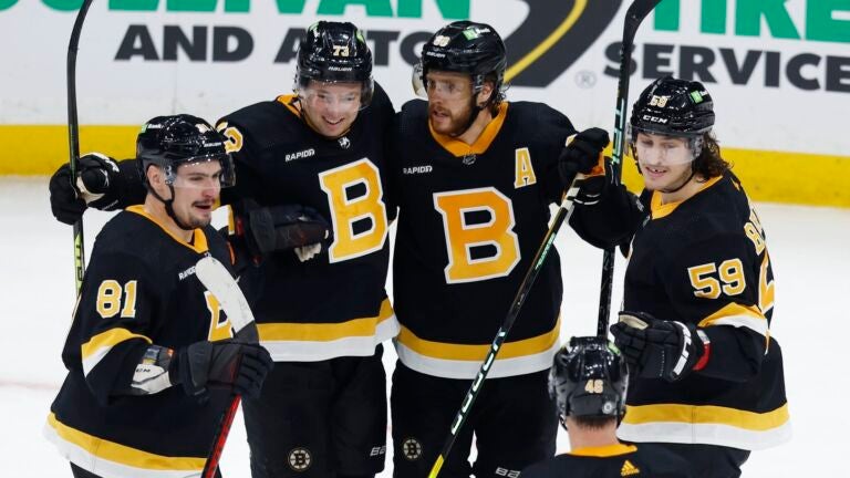Boston Bruins' David Pastrnak (88) celebrates his goal with Dmitry Orlov (81), Charlie McAvoy (73), Tyler Bertuzzi (59) and David Krejci (46) during the third period of an NHL hockey game against the New York Rangers, Saturday, March 4, 2023, in Boston.