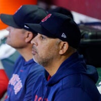 Boston Red Sox manager Alex Cora pauses in the dugout prior to a baseball game against the Arizona Diamondbacks Sunday, May 28, 2023, in Phoenix.