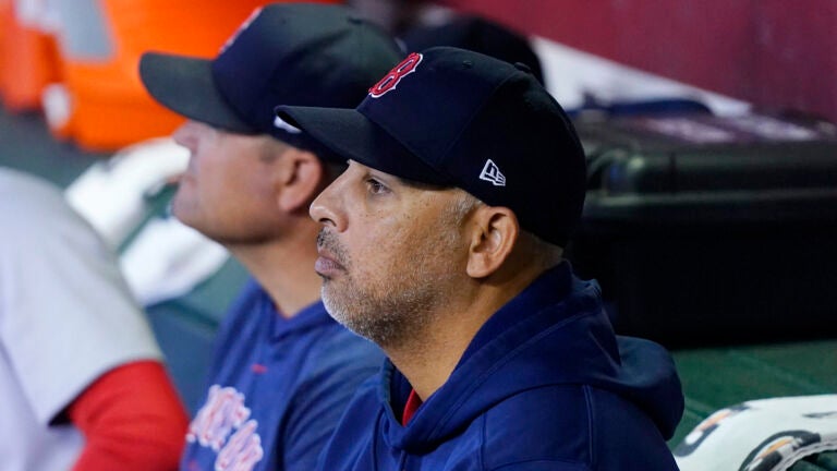Boston Red Sox manager Alex Cora pauses in the dugout prior to a baseball game against the Arizona Diamondbacks Sunday, May 28, 2023, in Phoenix.
