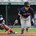 Boston Red Sox's Masataka Yoshida and Cleveland Guardians catcher Mike Zunino, left, watch Yoshida's double during the sixth inning.