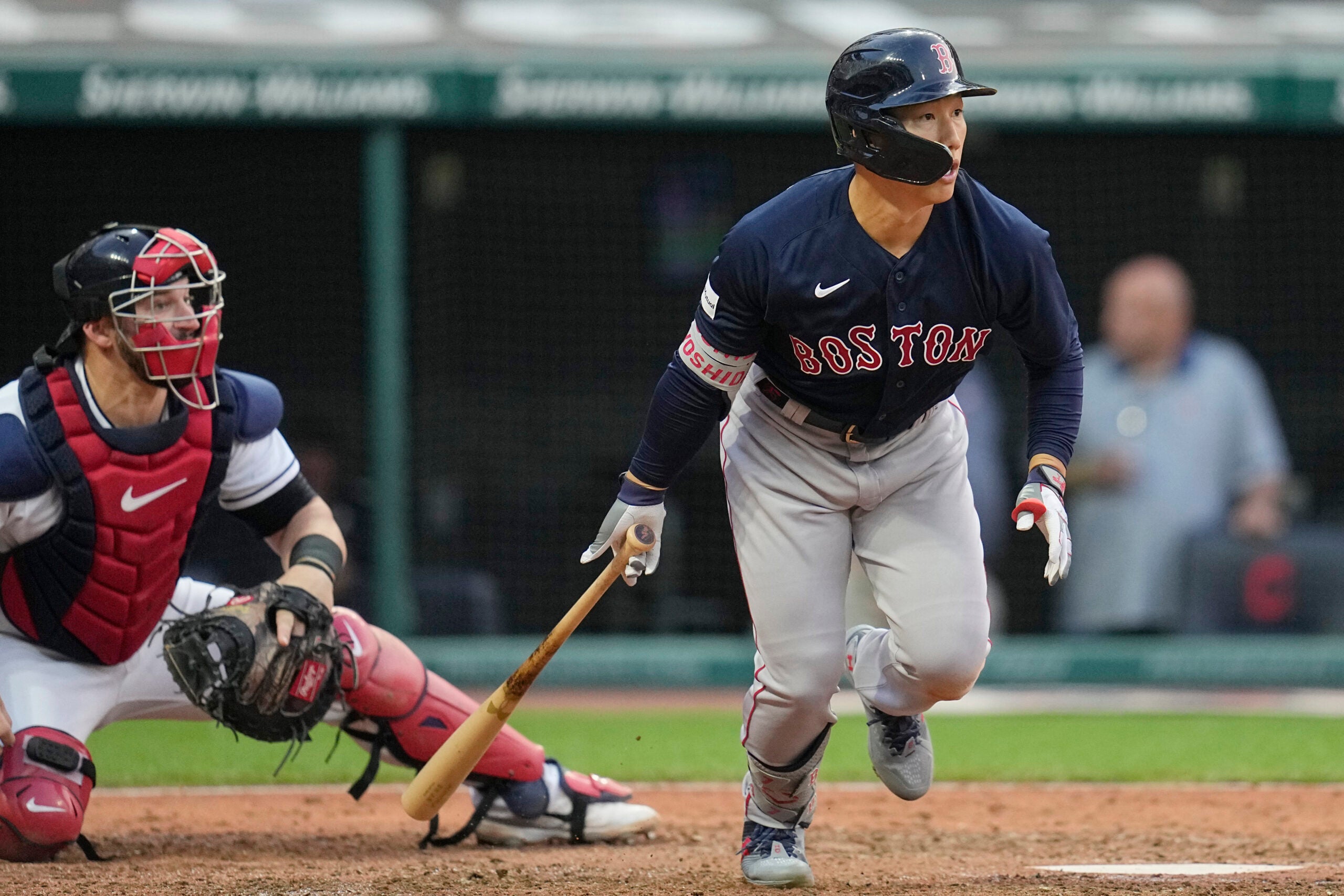 Boston Red Sox's Masataka Yoshida and Cleveland Guardians catcher Mike Zunino, left, watch Yoshida's double during the sixth inning.