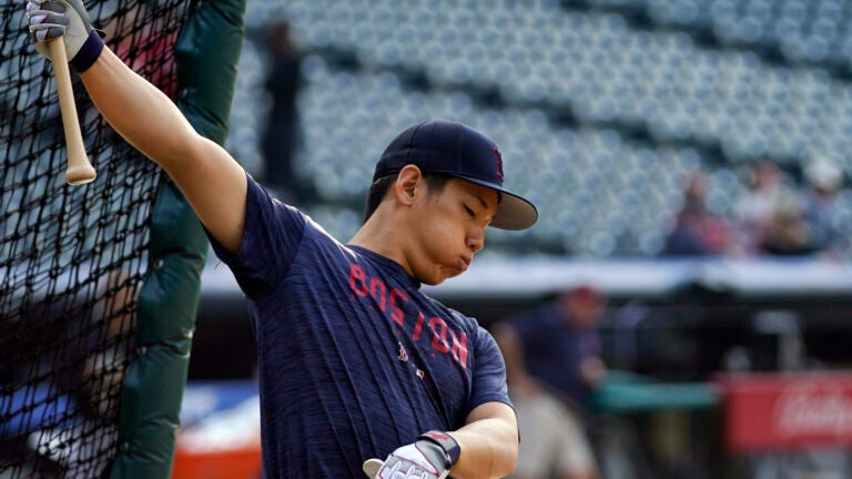 Boston Red Sox outfielder Masataka Yoshida warms up before a baseball game against the Cleveland Guardians.