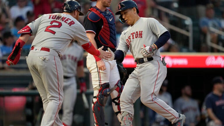 Boston Red Sox outfielder Masataka Yoshida celebrates with DH Justin Turner (2) after hitting a two-run home run against the Minnesota Twins.