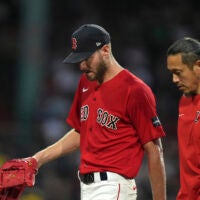 Boston Red Sox's Chris Sale, left, walks to the dugout after being removed during the fourth inning of the team's baseball game against the Cincinnati Reds, Thursday, June 1, 2023, in Boston.