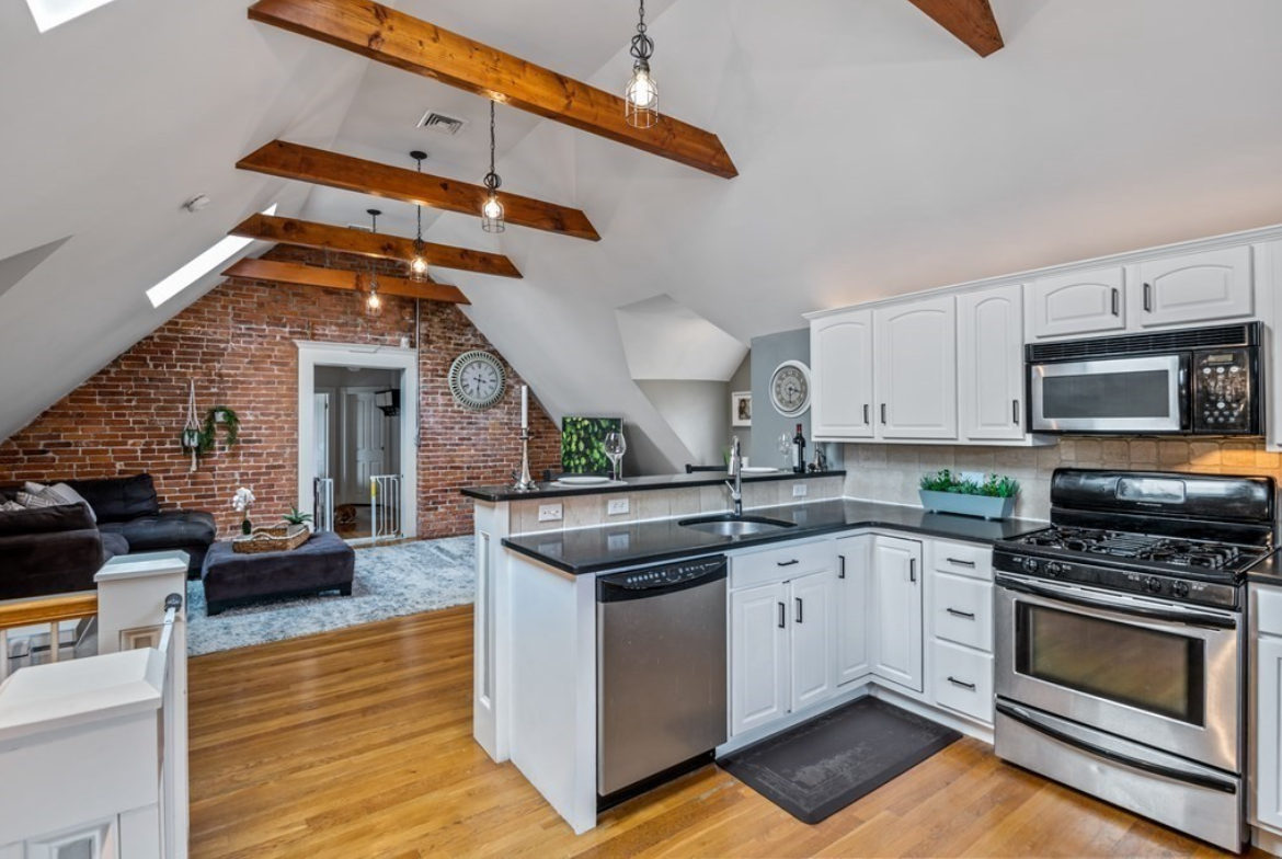 View of For under $600k, a Roslindale condo with exposed brick and beams