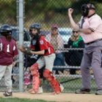 Umpire Brian Kennedy makes a call while officiating a game at the Deptford Little League complex in Deptford, N.J.