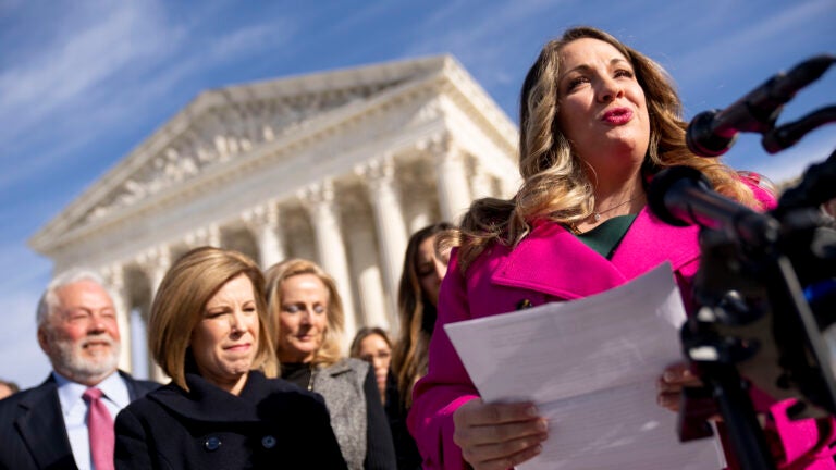 Lorie Smith, a Christian graphic artist and website designer in Colorado, right, accompanied by her lawyer, Kristen Waggoner of the Alliance Defending Freedom, second from left, speaks outside the Supreme Court in Washington, D.C., Monday, Dec. 5, 2022, after her case was heard before the Supreme Court.