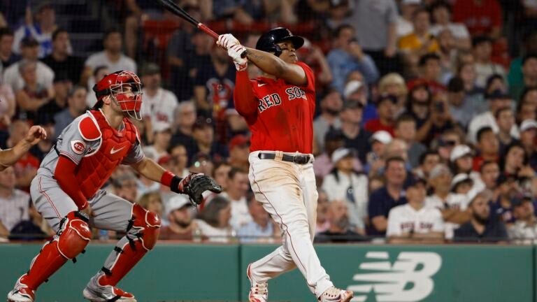 Rafael Devers #11 of the Boston Red Sox follows through on his go-ahead RBI-double during the eighth inning