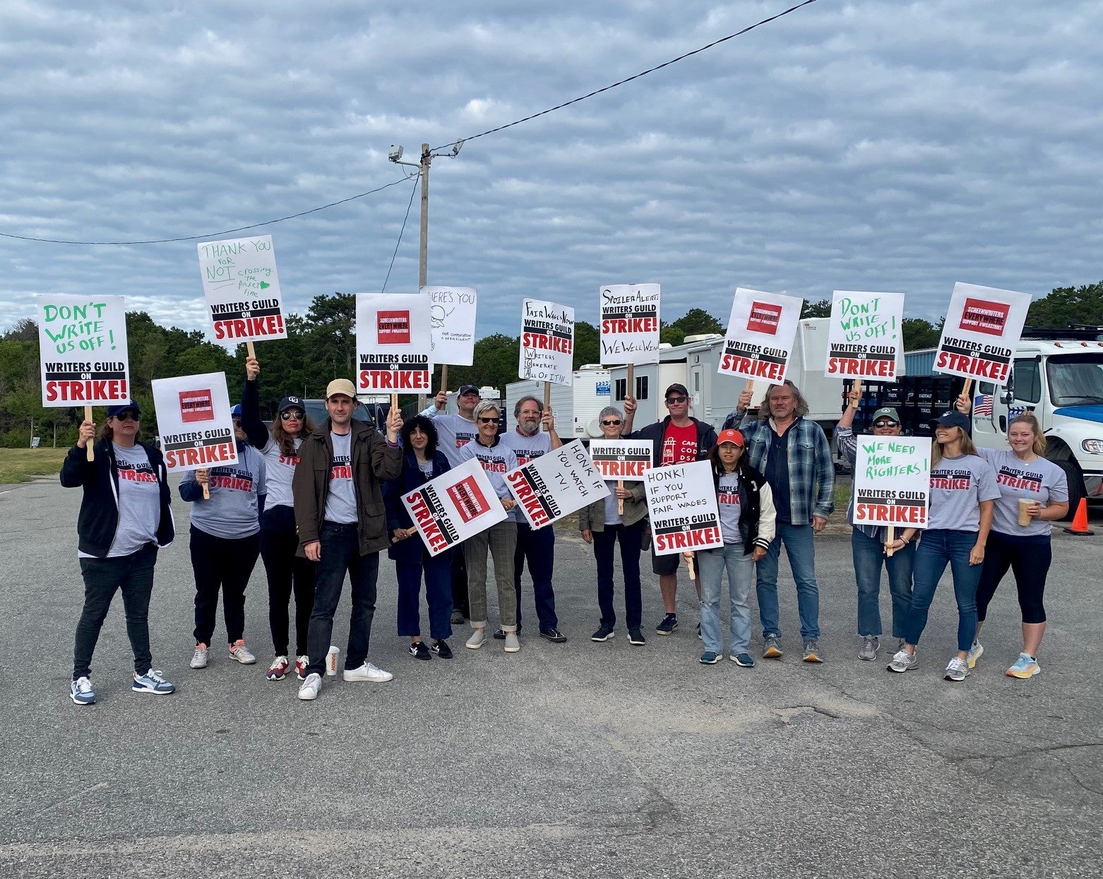 Members of the WGA posed with signs on Tuesday after shutting down production of the Netflix series "The Perfect Couple" on Cape Cod on Tuesday.