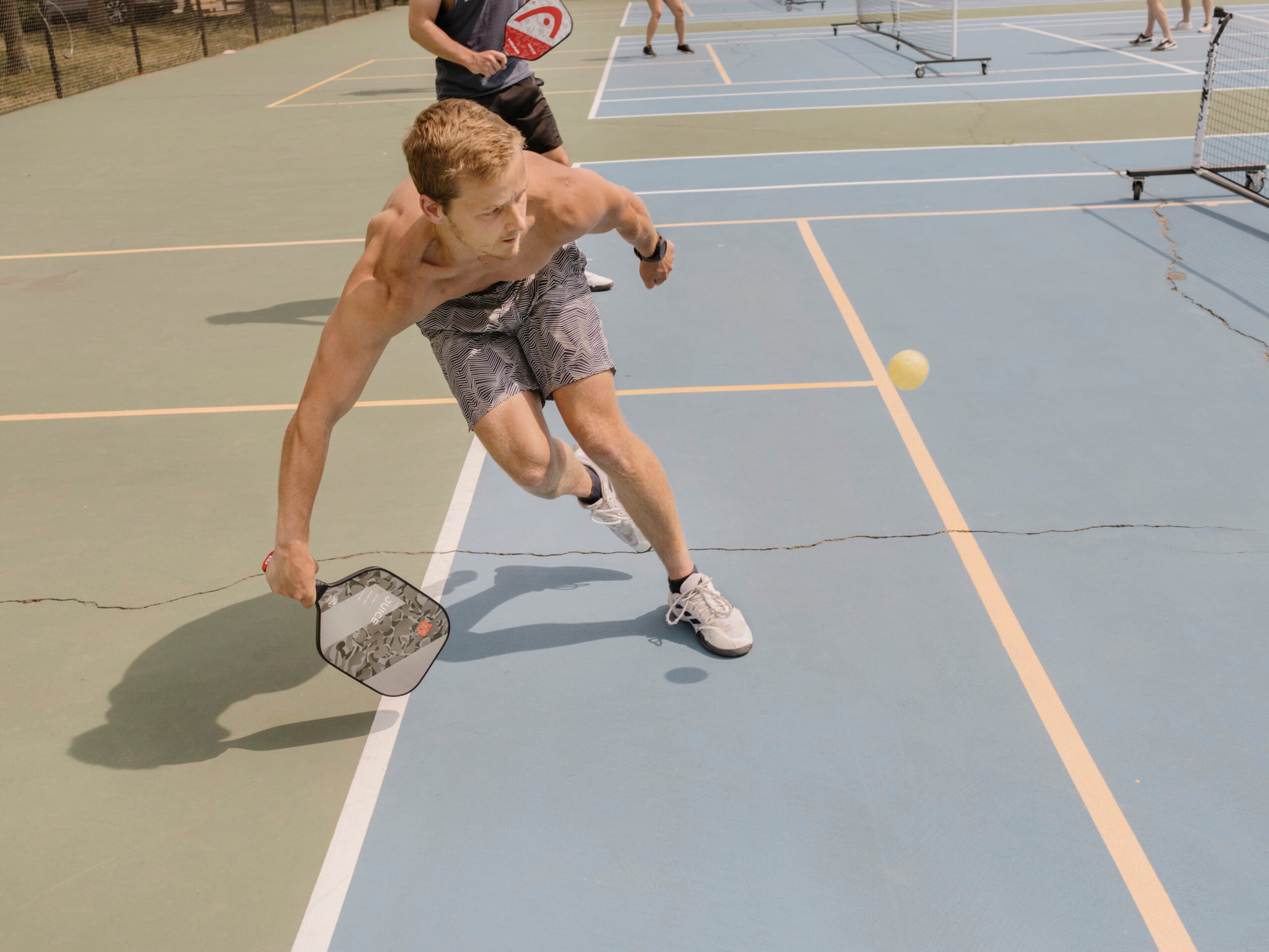 Hayden Sealander reaches for a ball while playing pickleball.
