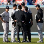 New York Yankees right fielder Aaron Judge, center right, is checked out after catching a fly ball
