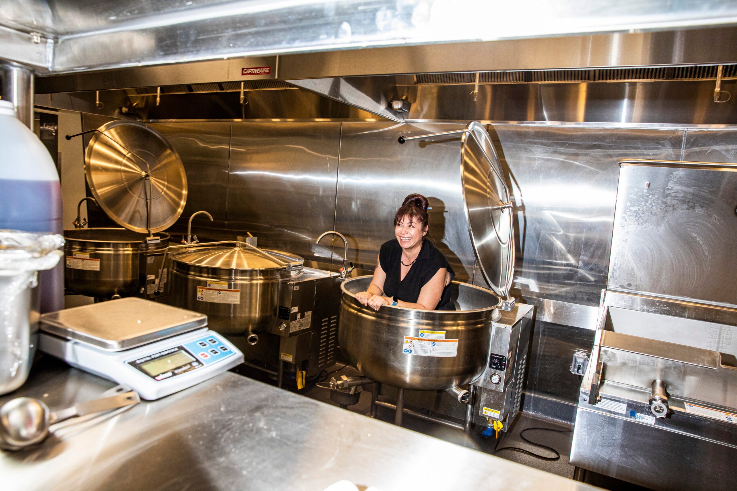 Executive chef Dana Rodriguez in a cooking vat at the refurbished Casa Bonita in Lakewood, Colo.