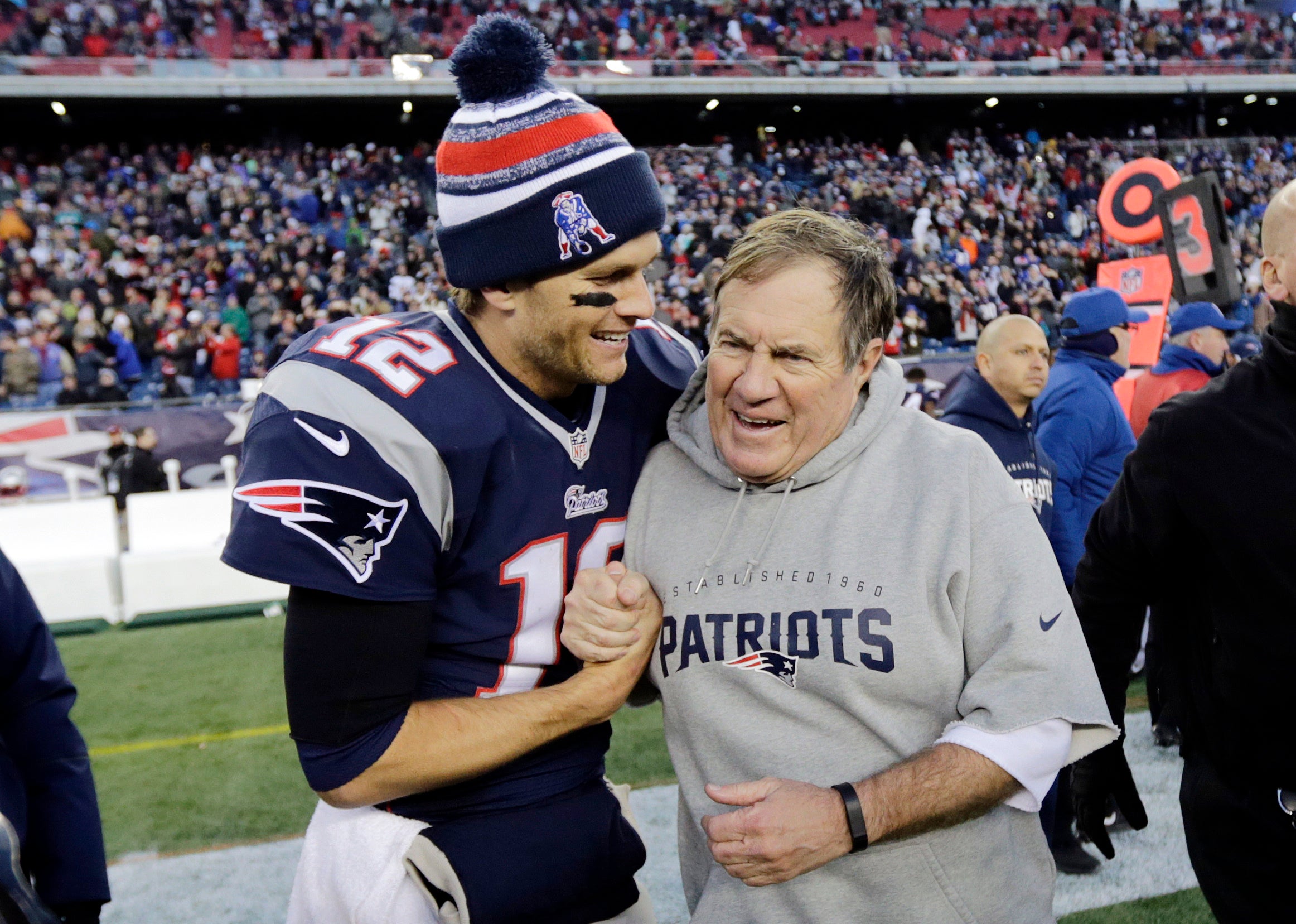 In this Dec. 14, 2014, file photo, New England Patriots quarterback Tom Brady, left, celebrates with head coach Bill Belichick after defeating the Miami Dolphins 41-13 in an NFL football game in Foxborough, Mass.