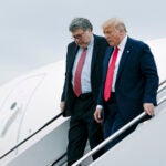 Donald Trump and Attorney General William Barr walk off Air Force One
