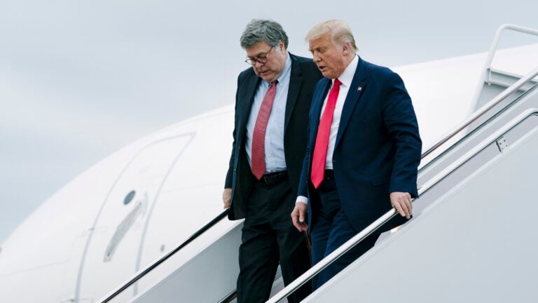 Donald Trump and Attorney General William Barr walk off Air Force One