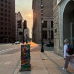 A hazy early morning sun rises over Boston Tuesday.