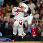 Minnesota's Kyle Farmer, right, celebrates with Byron Buxton after driving in the winning run during the 10th inning.