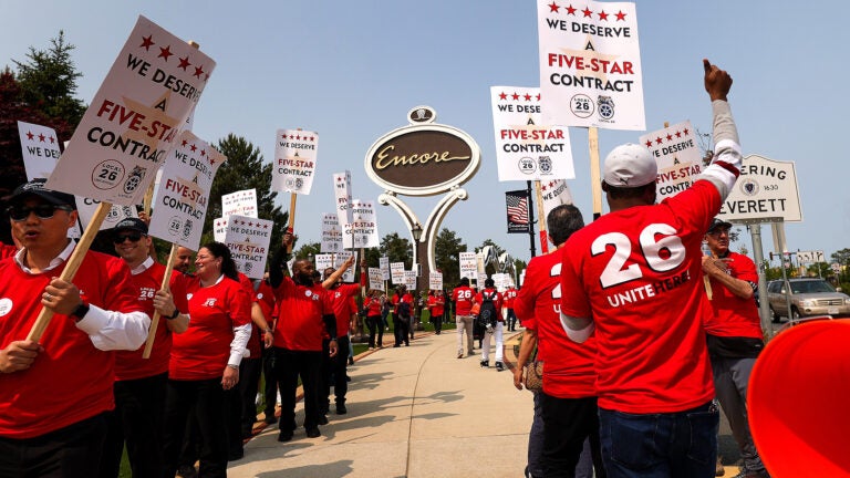 Encore Boston Harbor workers rally and picket outside the hotel and casino in Everett.