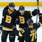 Boston Bruins center Charlie Coyle (13) celebrates with teammates Boston Bruins defenseman Derek Forbort (28) and Boston Bruins left wing Taylor Hall (71) after scoring late in the first period. The Boston Bruins host the Florida Panthers on October 30, 2021 at TD Garden in Boston, MA.